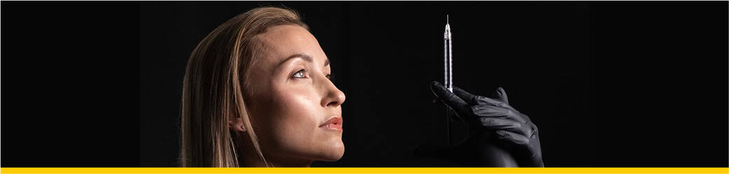 Aesthetic Nurse checking an injection needle